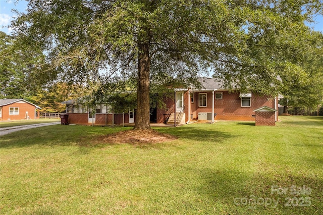 exterior space with central AC and a front lawn