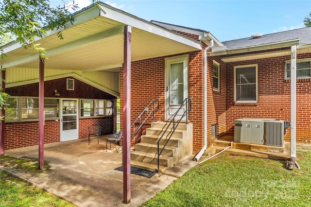 back of property with central AC unit and a patio area