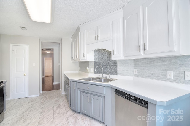 kitchen with stainless steel appliances, visible vents, light countertops, and a sink