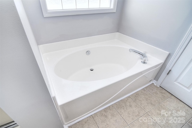 bathroom with a bath, tile patterned flooring, and a wealth of natural light