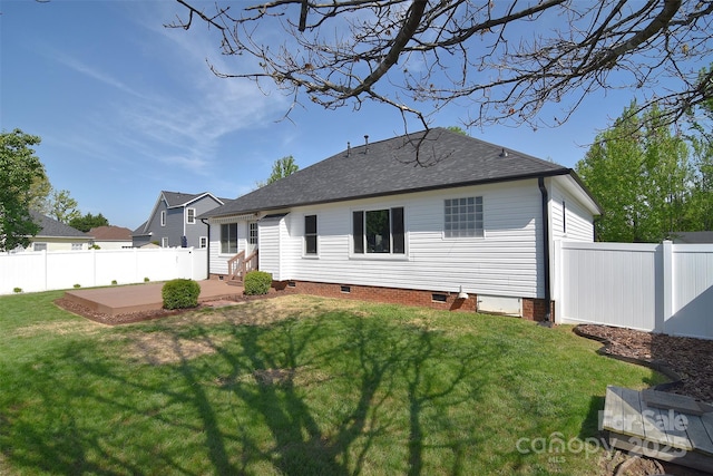 back of house with a patio area, a yard, crawl space, and roof with shingles