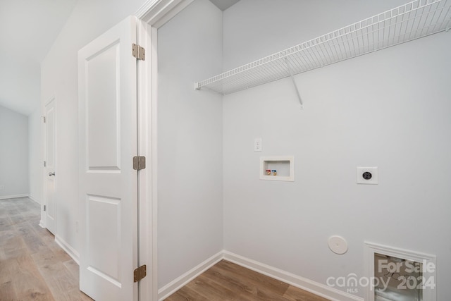 washroom with washer hookup, light wood-type flooring, electric dryer hookup, and gas dryer hookup