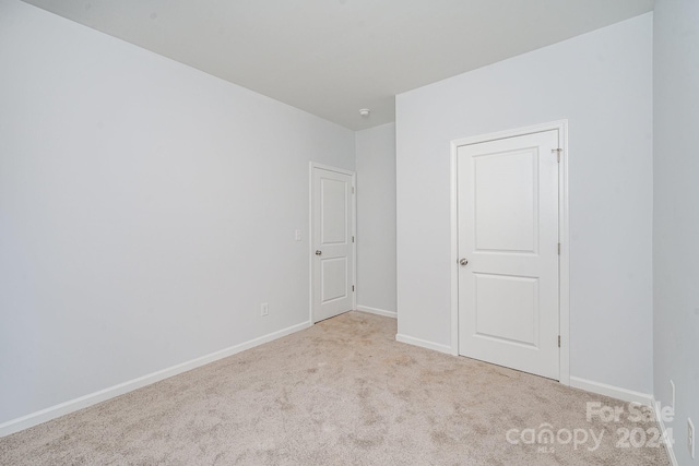 unfurnished bedroom with light carpet