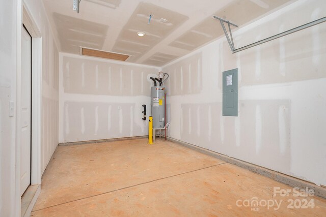 garage featuring water heater and electric panel