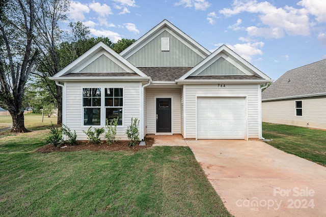 view of front of house with a garage and a front lawn