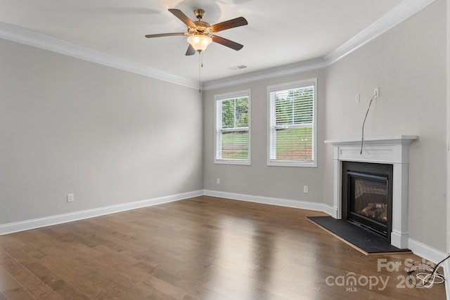 unfurnished living room featuring dark wood-type flooring, ceiling fan, and crown molding