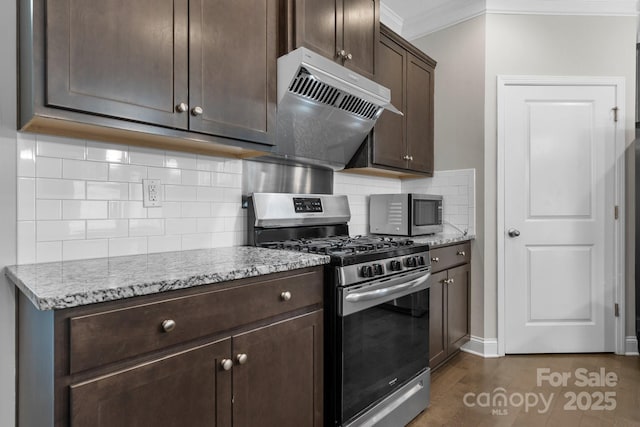 kitchen with extractor fan, light stone counters, crown molding, dark brown cabinets, and stainless steel appliances