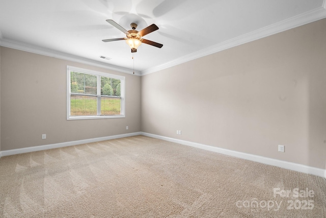 empty room featuring crown molding, light colored carpet, and ceiling fan