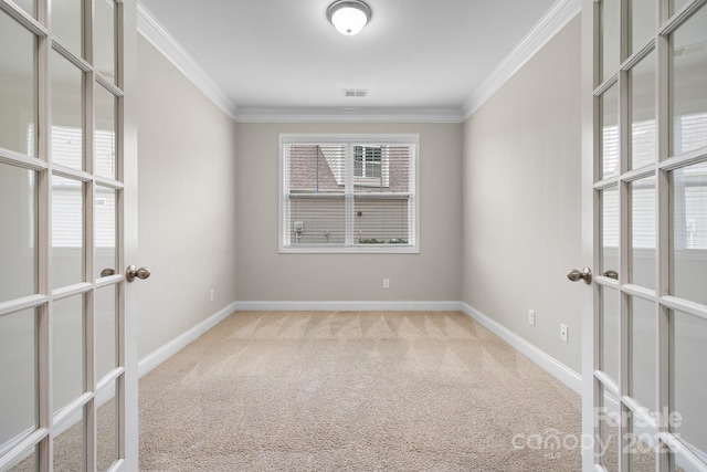 spare room with crown molding, carpet floors, and french doors