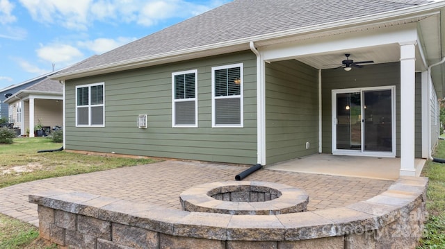 back of property with a patio, ceiling fan, and an outdoor fire pit