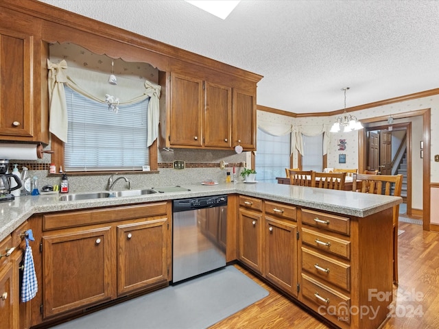 kitchen featuring stainless steel dishwasher, sink, pendant lighting, a chandelier, and light hardwood / wood-style floors