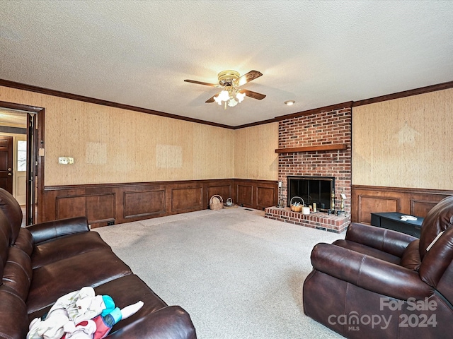 living room with crown molding, a brick fireplace, carpet flooring, ceiling fan, and a textured ceiling