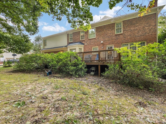 back of house with a deck