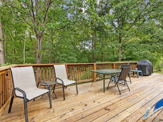 wooden terrace with a grill