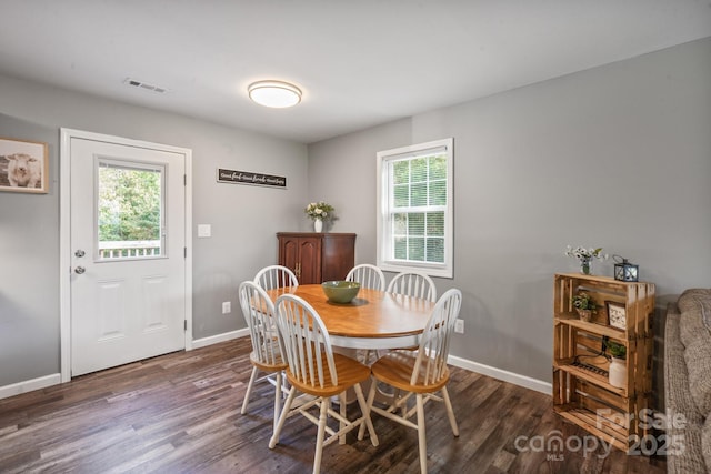 dining area with dark hardwood / wood-style flooring and a wealth of natural light