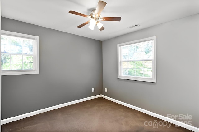 carpeted spare room featuring ceiling fan