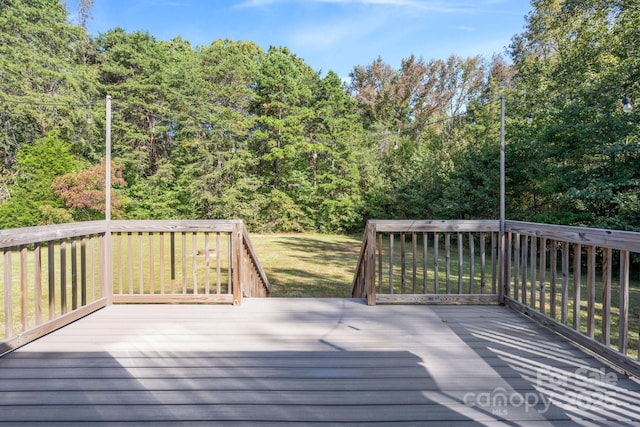 wooden terrace with a yard