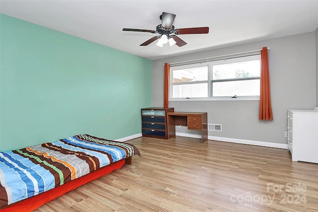 bedroom with ceiling fan and light hardwood / wood-style floors