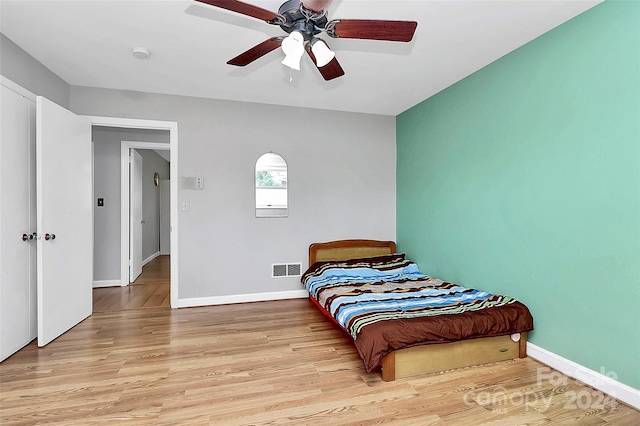 bedroom with ceiling fan and light wood-type flooring