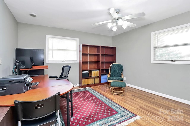 home office featuring wood-type flooring and ceiling fan