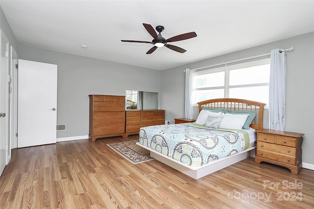 bedroom with ceiling fan and hardwood / wood-style floors