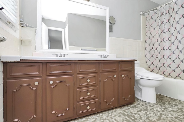 full bathroom featuring toilet, tile walls, vanity, and shower / bathtub combination with curtain