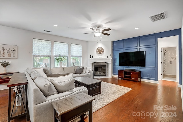 living room with dark hardwood / wood-style flooring and ceiling fan