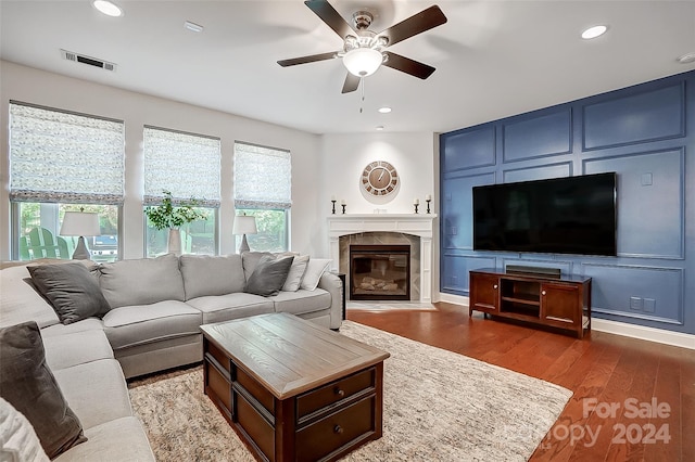 living room featuring wood-type flooring and ceiling fan