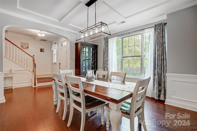 dining area with crown molding and dark hardwood / wood-style flooring