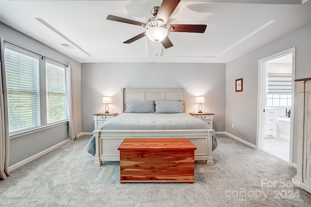 bedroom featuring ensuite bath, ceiling fan, and light colored carpet