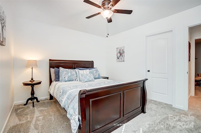 bedroom featuring ceiling fan and light carpet