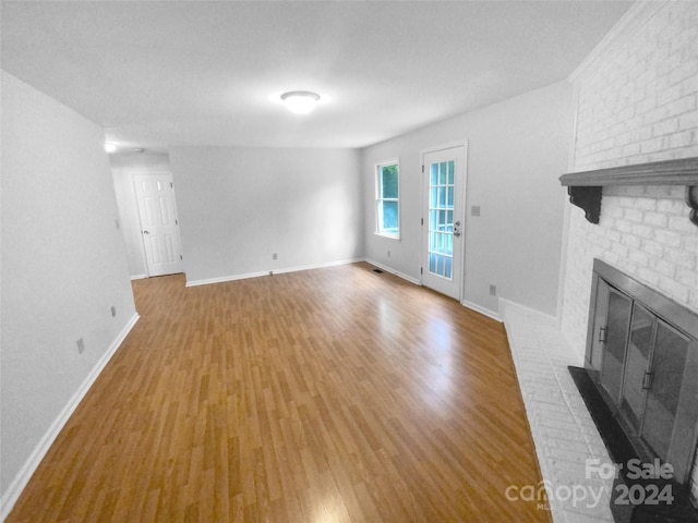 unfurnished living room featuring a fireplace and light wood-type flooring