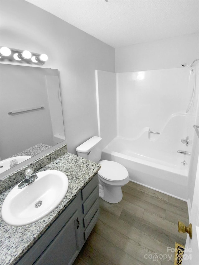 full bathroom with wood-type flooring, vanity, toilet, and shower / bathtub combination