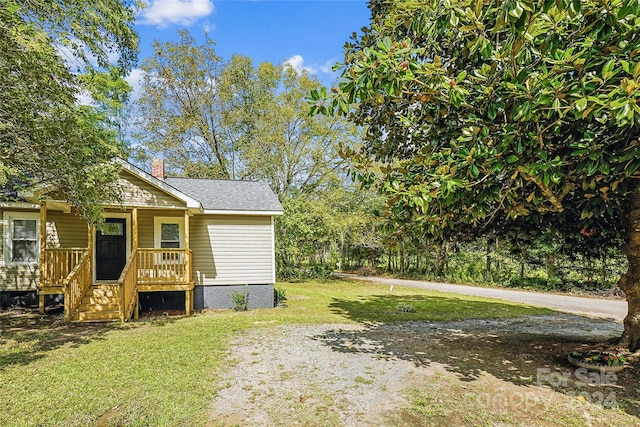 view of yard featuring covered porch