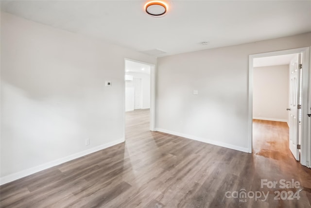 spare room featuring wood-type flooring