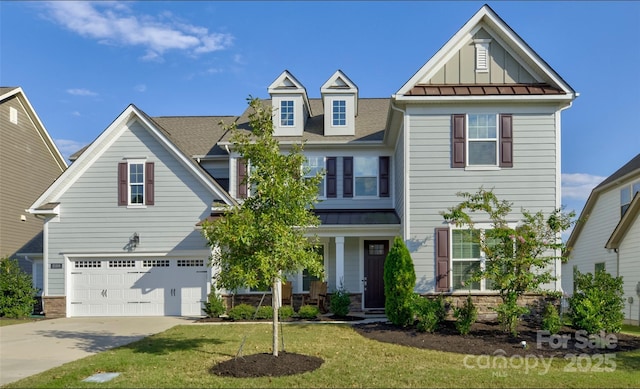 view of front of home featuring a garage and a front yard