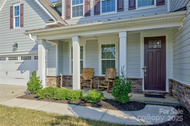 property entrance with a porch and a garage