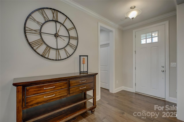 entrance foyer featuring crown molding and hardwood / wood-style flooring