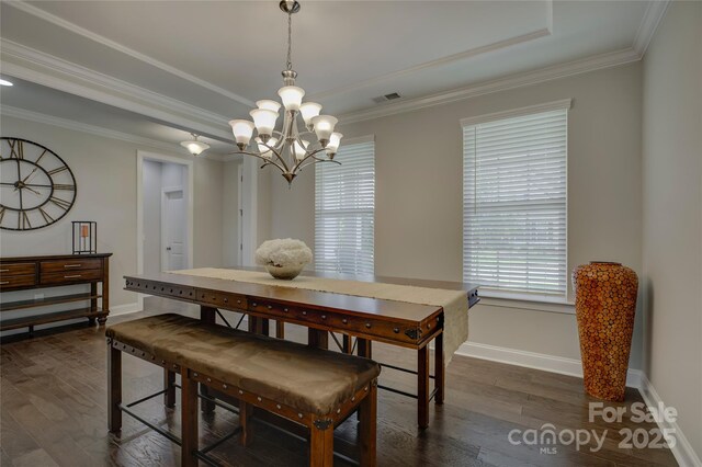 dining area with a chandelier, crown molding, and dark wood-type flooring