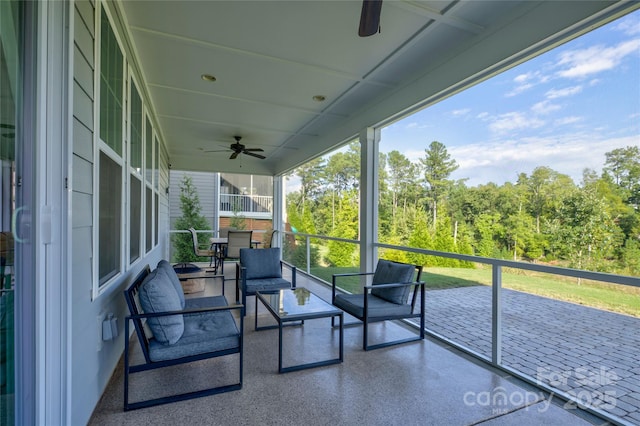 sunroom with plenty of natural light and ceiling fan