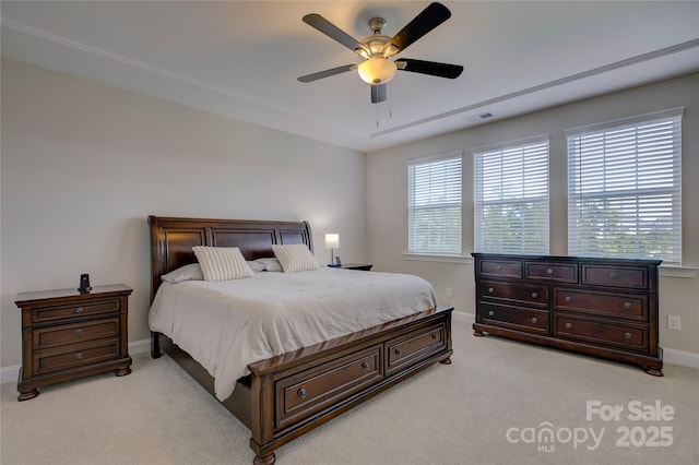 carpeted bedroom featuring multiple windows and ceiling fan