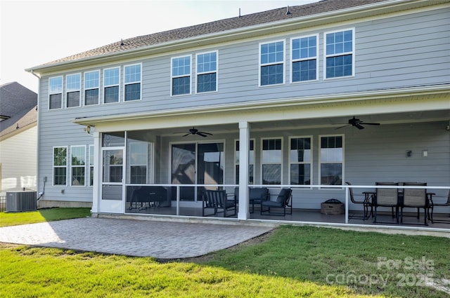 rear view of house with ceiling fan, a yard, cooling unit, and a patio