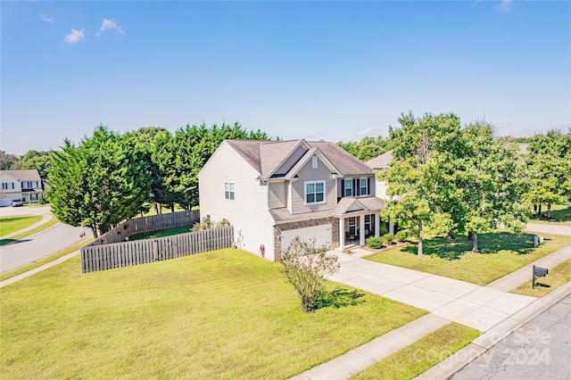 view of front of property featuring a front yard and a garage