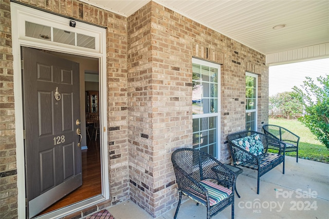 view of exterior entry with a porch