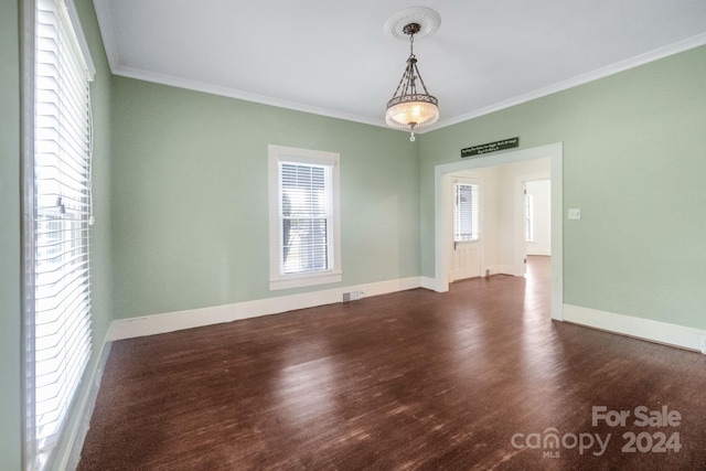 unfurnished room with crown molding and dark wood-type flooring