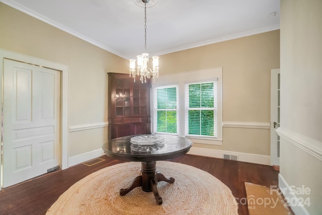 dining area with a chandelier, dark wood-type flooring, and crown molding