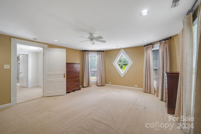 unfurnished bedroom featuring ceiling fan and light colored carpet