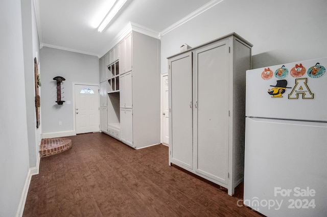 kitchen with ornamental molding, white cabinetry, dark wood-type flooring, and white fridge