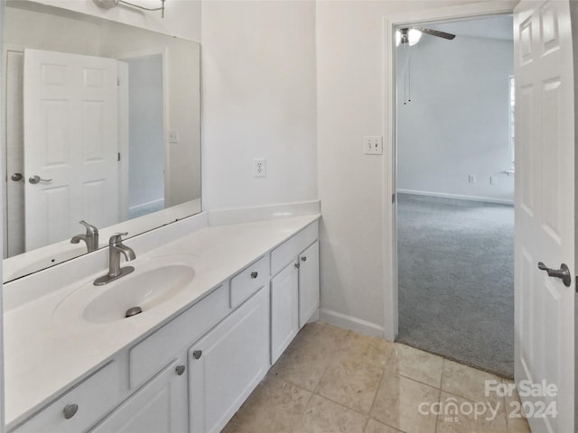 bathroom with tile patterned flooring, ceiling fan, and vanity