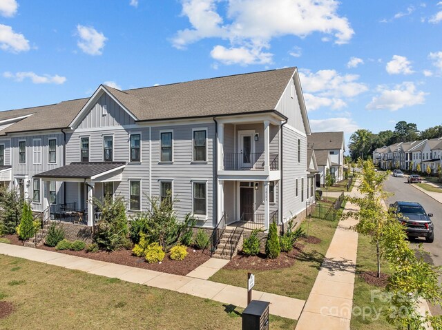 10193 Meeting House Dr NW, Huntersville, NC 28078 - multi unit property featuring a balcony, a front yard, board and batten siding, a residential view, and a porch